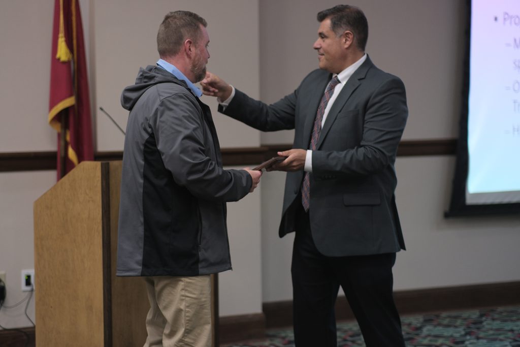 Brad Whittle, ERMCO Talent Acquisition Manager, stands on the left as he receives the Tennessee Department of Education Flagship Industry Partnership Award. The presentation takes place during the Tennessee Northwest Region FutureReadyTN Roadshow at the Dyersburg/Dyer County Chamber of Commerce on October 22 in Dyersburg, Tennessee.