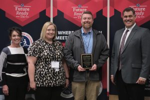 A photo of ERMCO employee Brad Whittle accepting Tennessee Department of Education's Flagship Industry of the Year Award