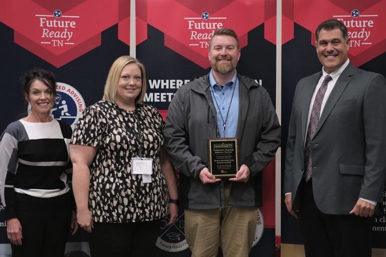 A photo of ERMCO employee Brad Whittle accepting Tennessee Department of Education's Flagship Industry of the Year Award