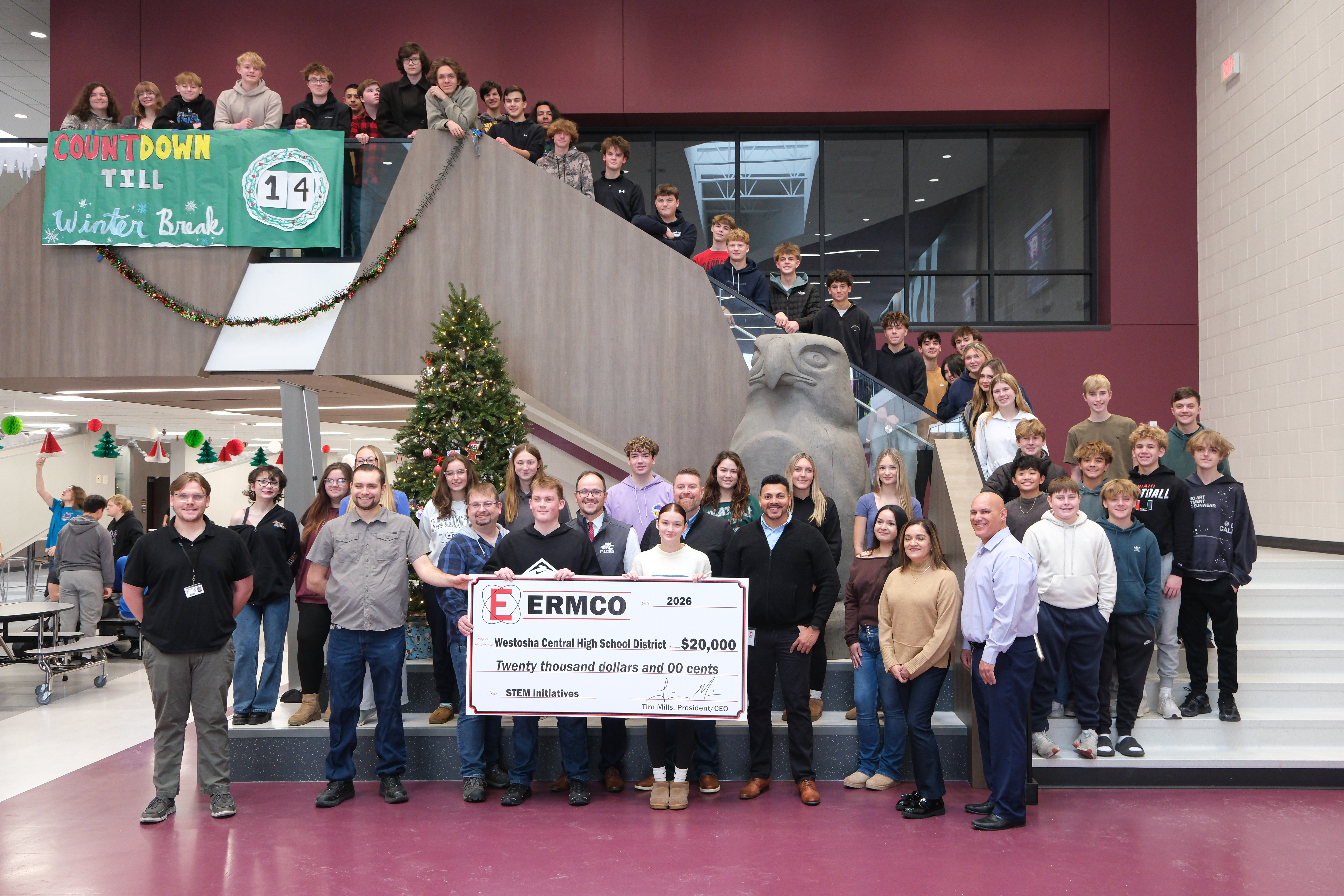 Person presenting a large ceremonial check to representatives of a Bristol-area school. The check is for supporting STEAM (Science, Technology, Engineering, Arts, and Math) programs. The setting appears to be indoors with the check prominently displayed in the foreground